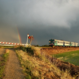 Un arcobaleno sembra salutare il transito di questo Regionale Santhià - Arona, formato da una coppia di ALn 663, negli ultimi giorni di esercizio della linea. 13 giugno 2012. Foto di Simone Grimaldi, Bioglio.